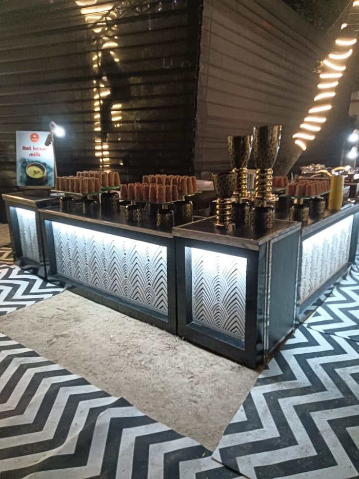 Illuminated drinks counter at an evening event
