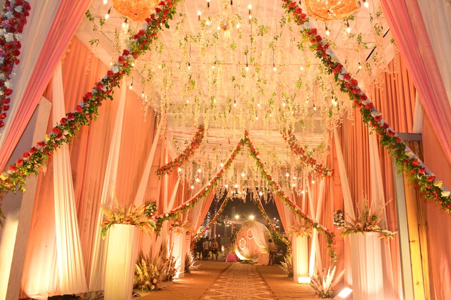 Floral tunnel entrance with warm fairy lights