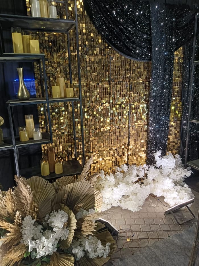 Gold sequin backdrop with pampas grass styling