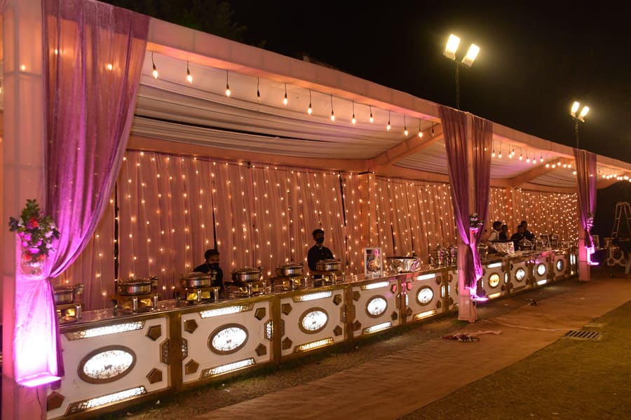 Catering counter styled with drapes and fairy lights